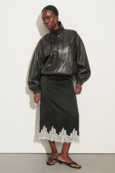 Cynthia wearing AMELINE BLACK SATIN MIDI SKIRT