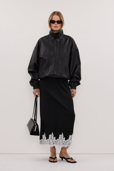 Zoe wearing AMELINE BLACK SATIN MIDI SKIRT