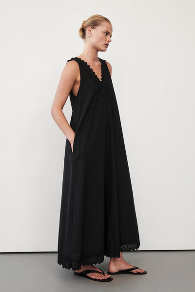 Zoe wearing ANNABEL BLACK SLEEVELESS V NECK MIDI DRESS