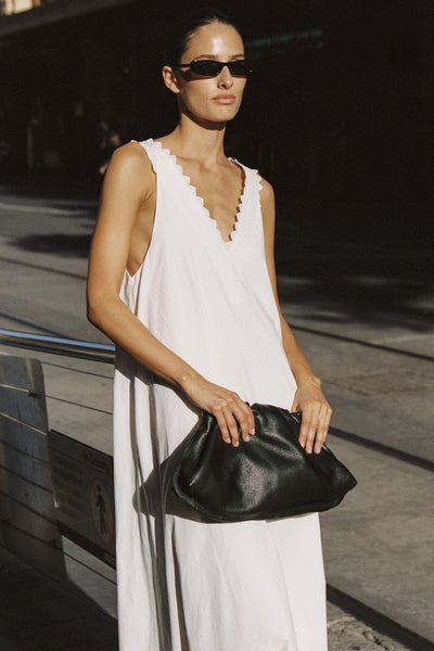 Adrienne wearing ANNABEL WHITE SLEEVELESS V NECK MIDI DRESS