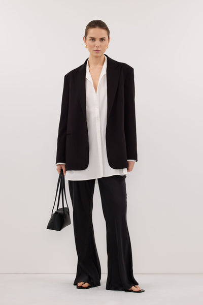 Stas wearing MELANI BLACK SILK BIAS PANT