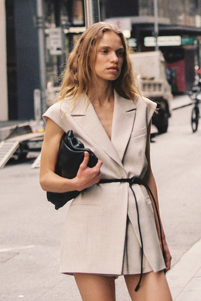 Zoe wearing CYRUS NATURAL SLEEVELESS WRAP VEST