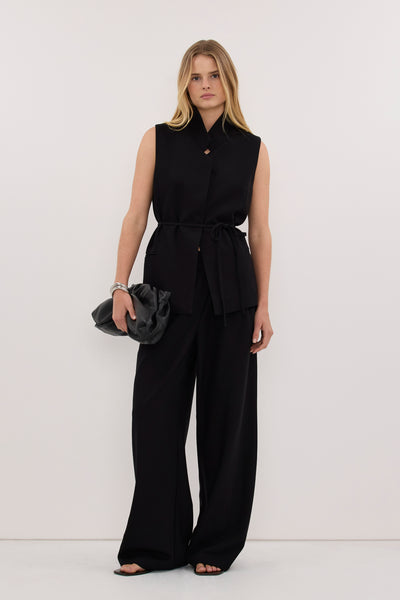 Zoe wearing VIDA BLACK STAND COLLAR VEST TOP