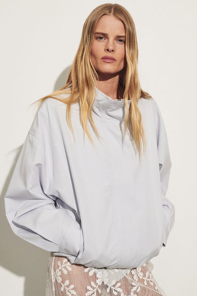 Zoe wearing RORY CORNFLOWER LIGHTWEIGHT TRACK JACKET