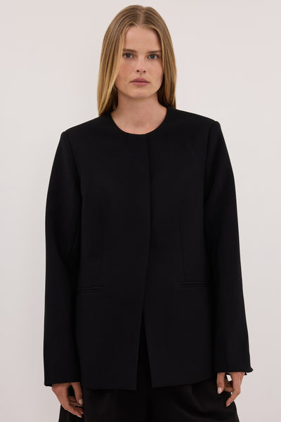 Zoe wearing CHIARA BLACK COLLARLESS BLAZER