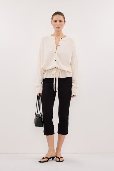 Stas wearing SAILOR IVORY BELTED CARDIGAN
