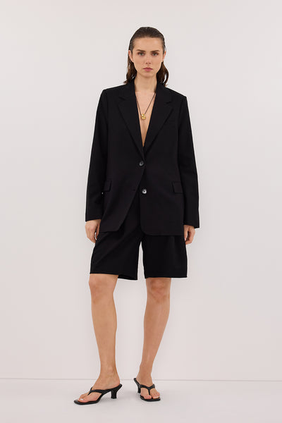 Stas wearing LIZA BLACK TAILORED BERMUDA SHORT