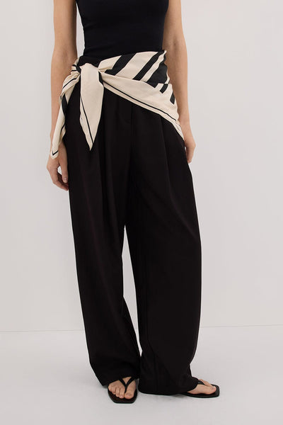 Stas wearing EDEN BLACK TAILORED PANT