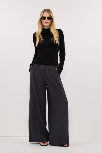 Zoe wearing ANGEL BLACK RAGLAN FUNNEL NECK TOP