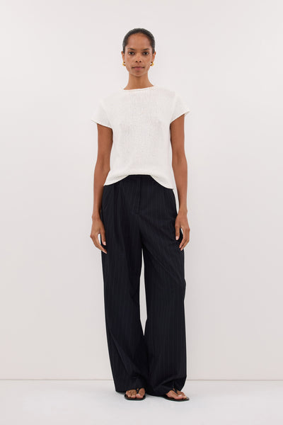 Kristen wearing LEO OFF WHITE KNIT TOP