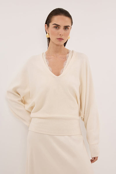 Stas wearing LUMI CREAM V NECK MERINO KNIT JUMPER