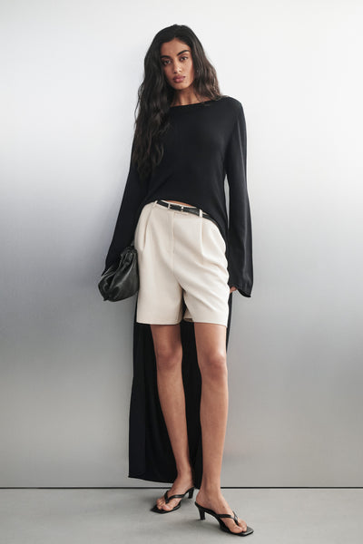 Anaya wearing DAPHNE BLACK KNIT CAPE TOP